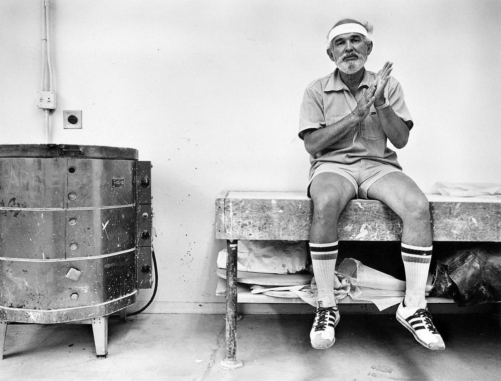 Artist sitting on a studio work bench