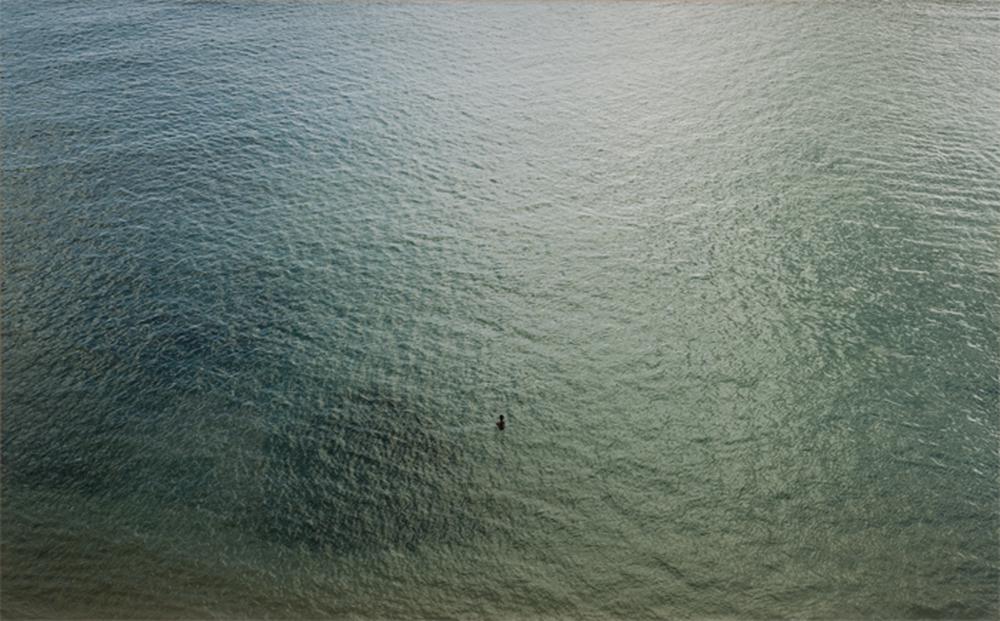 aerial view of a textured body of water disturbed by wind