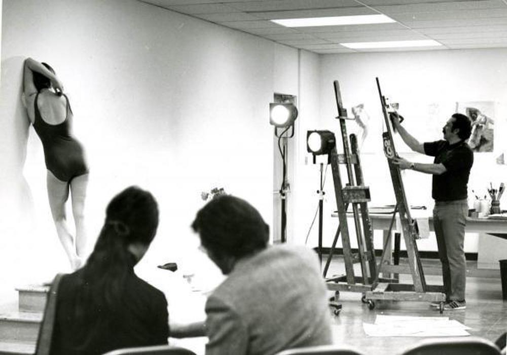 man standing in a classroom giving instruction