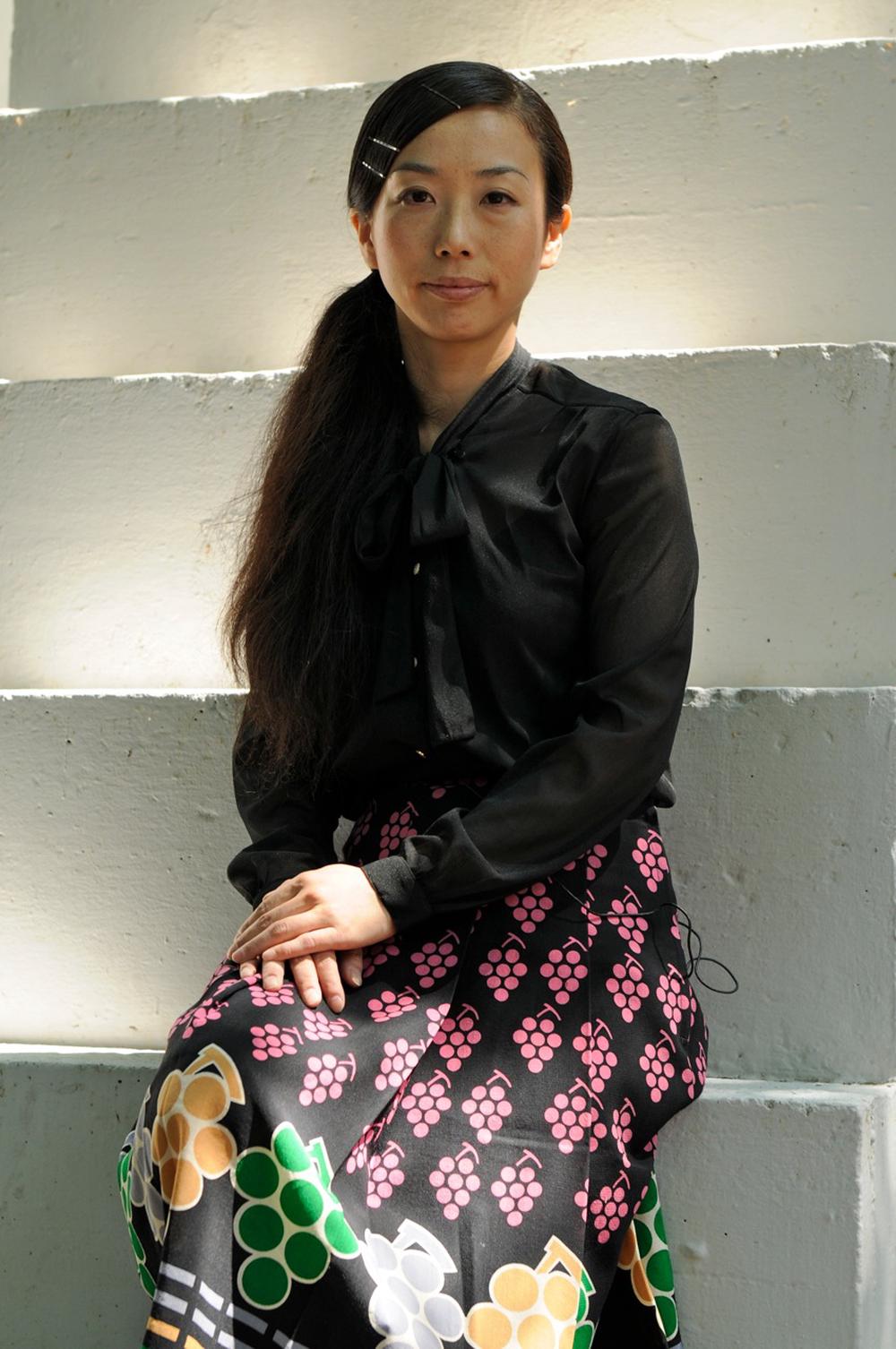 portrait of young, seated, asian woman